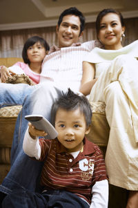 Family watching tv at home