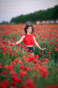 Young woman standing amidst flowers