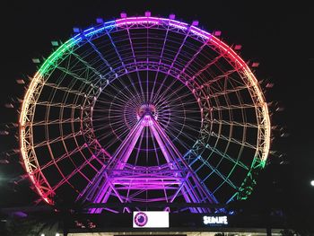 Low angle view of ferris wheel against sky at night