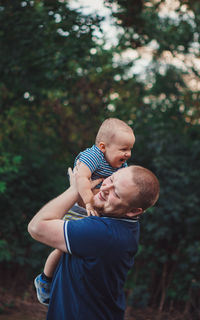 Father and son against trees