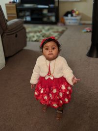 Portrait of baby girl standing at home