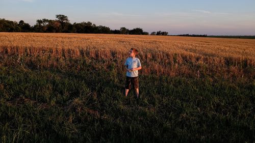 Rear view of a girl standing in field