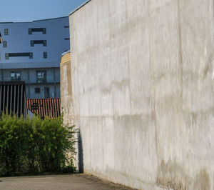 Footpath by building against sky