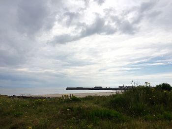 Scenic view of calm sea against cloudy sky