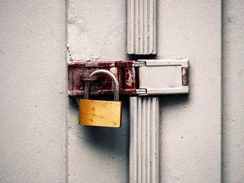 Close up of padlock on white door