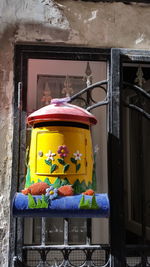 Yellow flowers on window of building