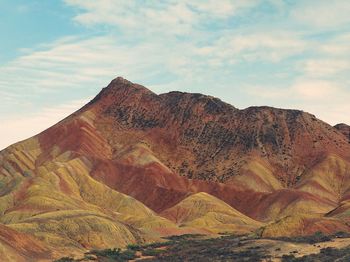 Scenic view of mountain against cloudy sky