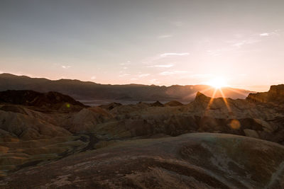 Scenic view of desert against sky during sunset