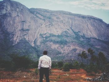 Rear view of man standing on mountain