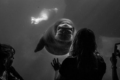 Woman swimming in aquarium