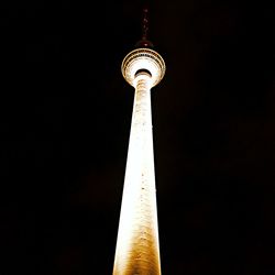 Low angle view of fernsehturm tower at night