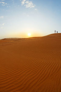 Scenic view of desert against sky during sunset