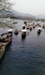 Boats moored in lake against sky