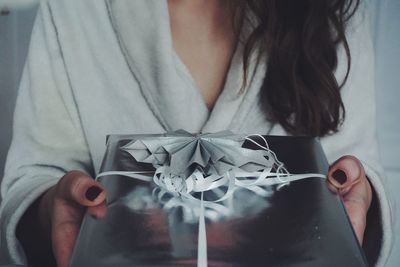 Midsection of woman holding gift box