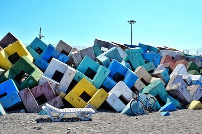 Multi colored umbrellas on beach against blue sky