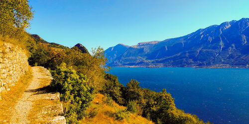 Scenic view of mountains against clear blue sky