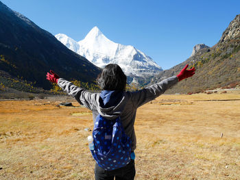 Rear view of man standing on mountain