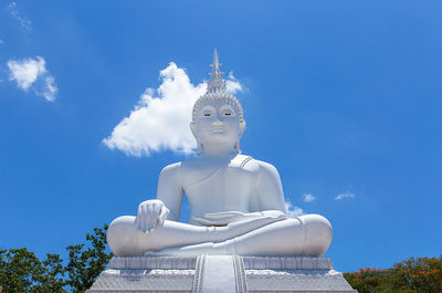 Low angle view of statue against blue sky