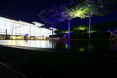 Reflection of illuminated building in water at night