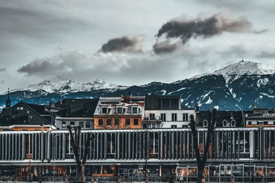 Buildings in city against sky during winter