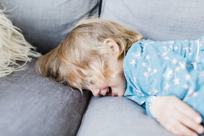 Cute girl sleeping on bed at home