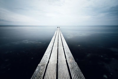 Pier over sea against sky