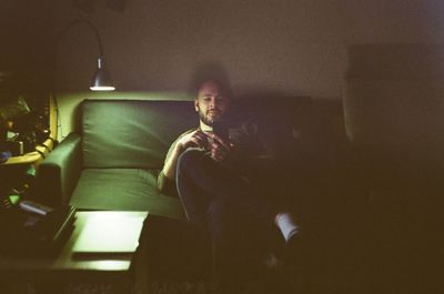 Portrait of young man sitting at home