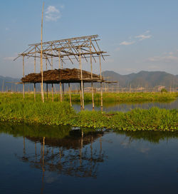 Built structure on lake against sky