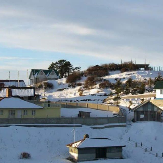 building exterior, architecture, built structure, snow, cold temperature, winter, sky, house, weather, residential structure, residential building, cloud - sky, season, cloud, roof, water, high angle view, frozen, cloudy, covering