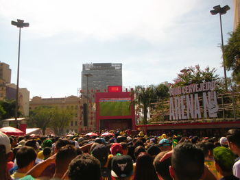 People on street in city against sky