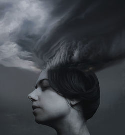 Digital composite image of young woman with clouds 