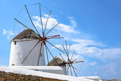 Low angle view of traditional windmill against sky