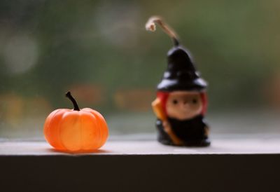 Close-up of pumpkin and halloween candlelight against blurred background