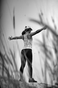 Full length of young woman standing against blurred background