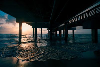 Pier over sea during sunset