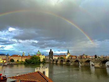 Rainbow over river moldau and  14th century stone charles bridge against sky in prague