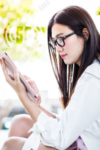 Young woman looking away while using smart phone