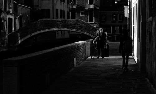 People walking on street in city at night