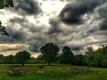 Scenic view of grassy field against cloudy sky