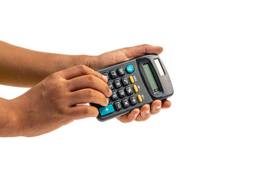Close-up of hand holding camera over white background