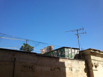 Low angle view of built structure against clear blue sky