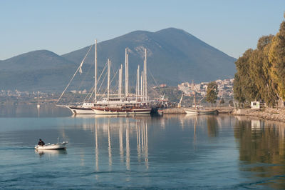 Sailboats in sea against clear sky