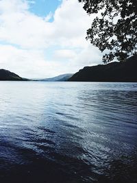 Scenic view of lake against cloudy sky