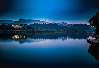 Scenic view of lake against sky at night