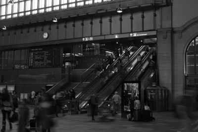 People at railroad station in city at night