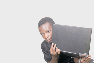 Portrait of a young man against white background