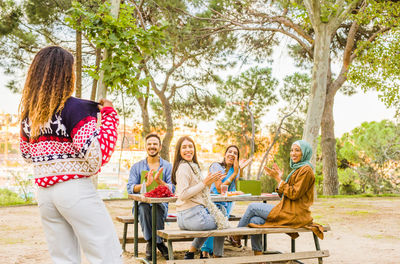 Cheerful people enjoying breakfast outdoors