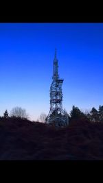 Low angle view of silhouette built structure against clear blue sky