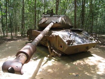 Garbage can on field in forest