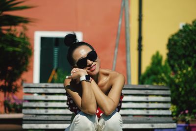 Midsection of woman holding sunglasses